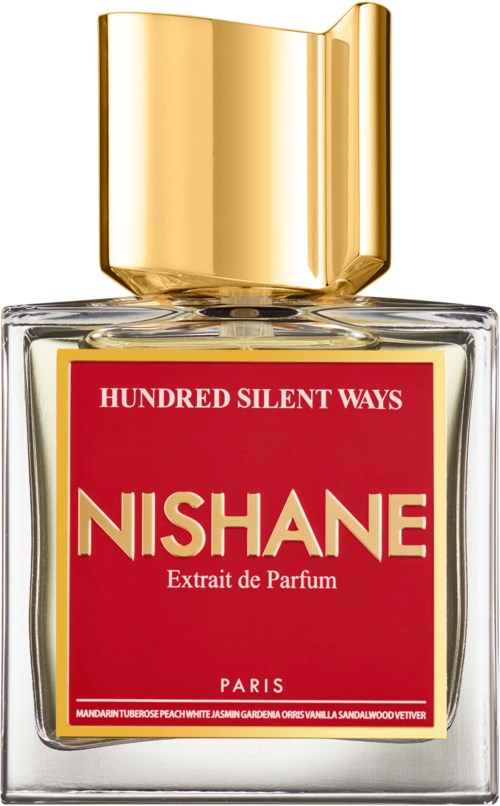 Een parfumfles met rood etiket en gouden dop, gemerkt 'NISHANE' en 'Extrait de Parfum' uit Parijs.