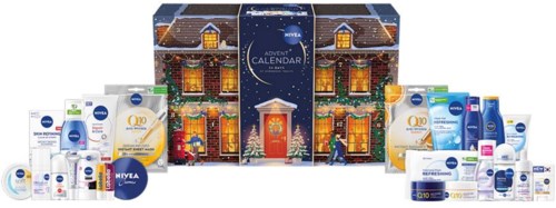 Beauty products and skincare items arranged around a festive advent calendar with a house design and Christmas themes.