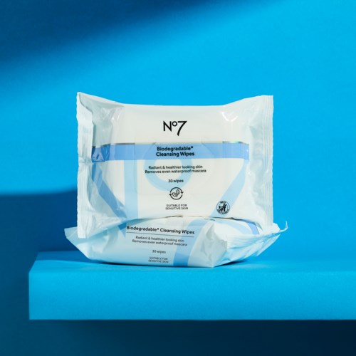 A white pack of biodegradable cleansing wipes with blue accents against a blue background.