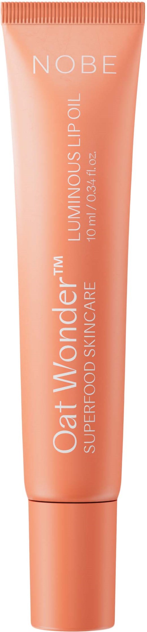 En persikfärgad tub med Nobe Oat Wonder Lip Oil, text finns på förpackningen.