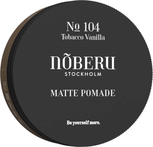 A round black container with white text advertising tobacco vanilla and matte pomade. The brand is NÖBERU Stockholm.