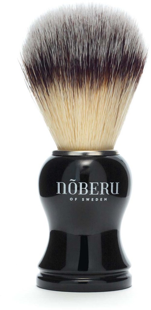 A shaving brush with black handle, white and dark bristles, and 'NÖBERU OF SWEDEN' text on handle.