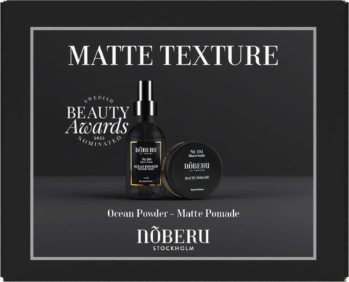 Box mit schwarzen Schönheitsprodukten von Nöberu, inklusive Ocean Powder und Matte Pomade, mit Auszeichnungen.