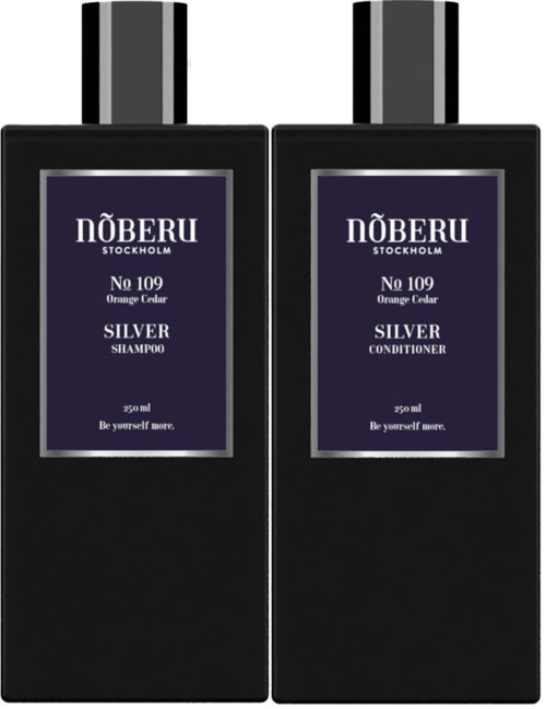Zwei schwarze Flaschen mit Nummer 109 Orange Cedar, eine Shampoo und die andere Conditioner, beide mit Silberschrauben.