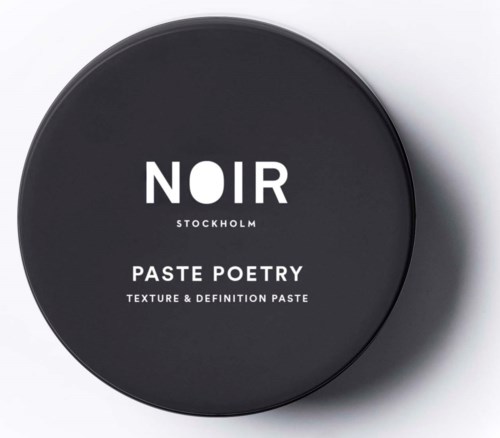 A round black container with white text that says Noir, Stockholm, Paste Poetry, and details about texture and definition.