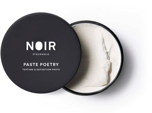 A black round container open to show white paste inside, labeled 'NOIR Stockholm Paste Poetry.'
