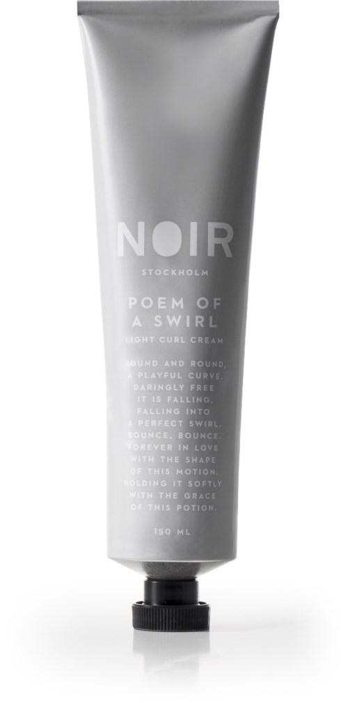 A silver tube with black cap, labeled 'NOIR', contains hair care product and has descriptive text on it.