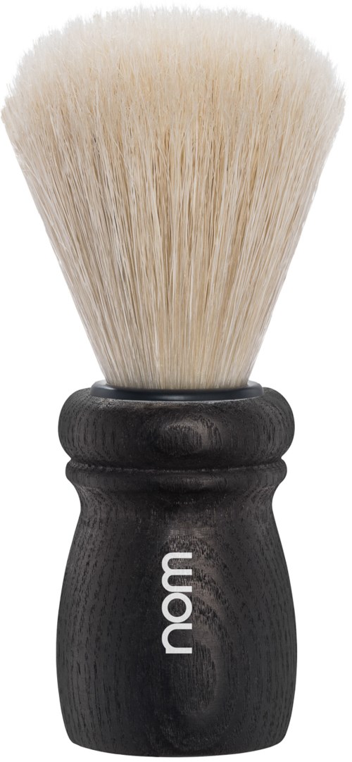 A black handle shaving brush with white bristles, branded with the word "nám".