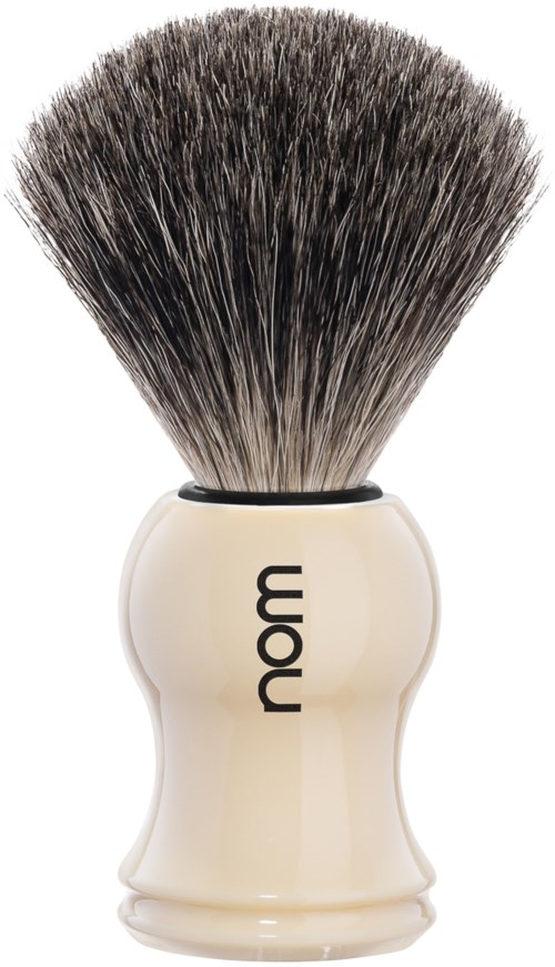 A shaving brush with a beige handle and black and white bristles.