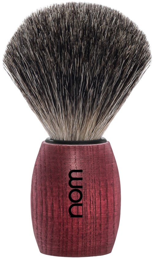 A shaving brush with a pink handle and black and white bristles.