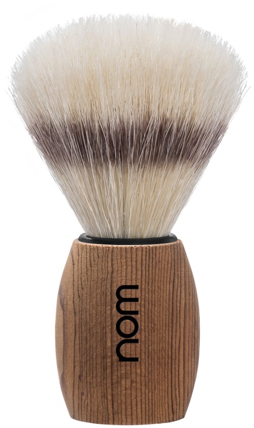 A shaving brush with a wooden handle and soft bristles, labeled "nom" on the handle.