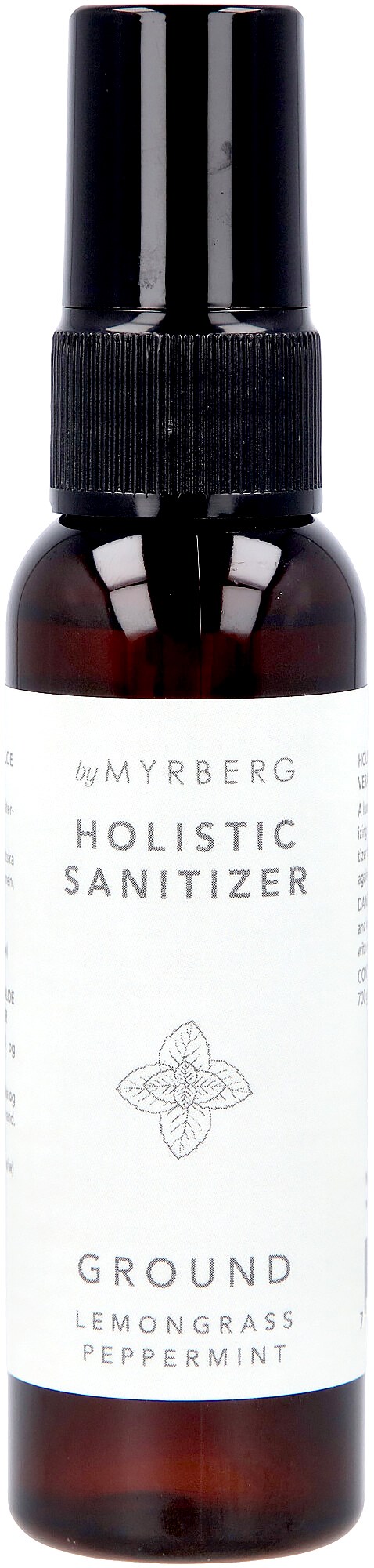 En liten brun flaska med svart spraylås, märkt med en vit etikett för holistisk desinfektion med citronlindning och pepparmynta.