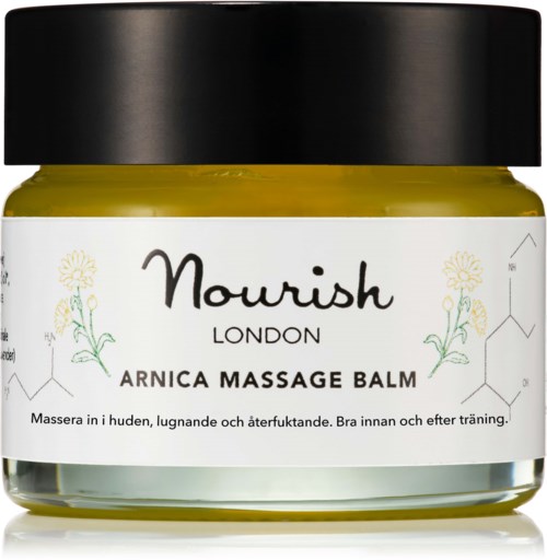 Nourish London Arnica Massage Balm in einem Glas, für Haut entspannung und Erholung, mit schwarzem Deckel und Blumenmuster.