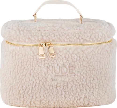 A soft, fluffy beige bag with a gold zipper and the word 'NUDE' embroidered on front.