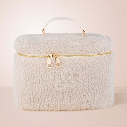 A soft, white, fluffy bag with a handle and gold zipper, with the word 'NUDE' on it.