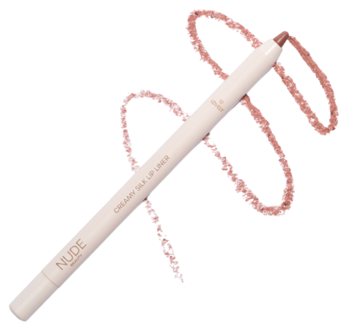 A white lip liner pen with pinkish color outlining a swirl on black background. The pen is labeled 'NUDE' and 'CREAMY SILK LIP LINER.'