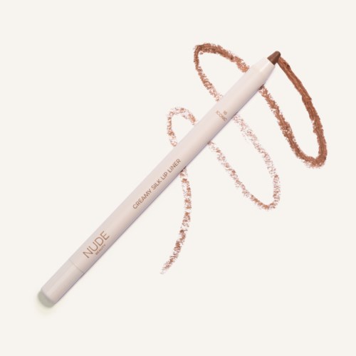 A white makeup pencil labeled 'NUDE' and 'CREAMY SILK LIP LINER', with brown lines and a circle drawn on background.