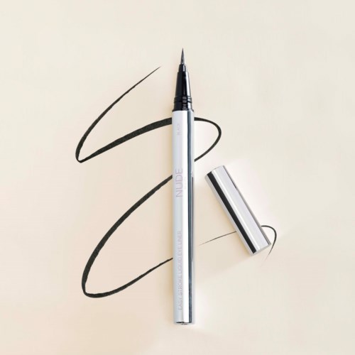 A silver pen with black ink drawing loops on a light background.