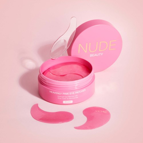 Pink eye patches in a round container with a lid, with two patches outside. The box says 'NUDE BEAUTY' and 'Heavenly Pink Eye Patches.'