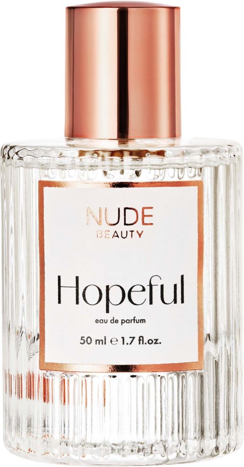 A perfume bottle labeled 'Hopeful' from Nude Beauty, with a rose gold cap and ribbed glass design.