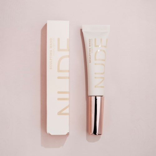 A white tube and box with the words 'NURSE' and 'Sculpting Wand' on a pink background.