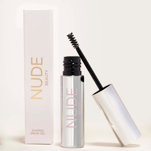 En bryngel i en sølvrør med en svart børste, ved siden av esken merket "Nuude Beauty".