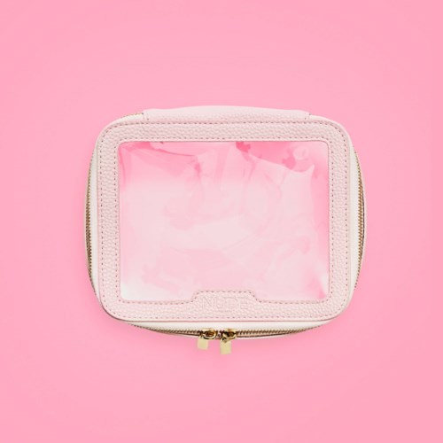 A small, pink, zipped case with clear plastic top, placed on a pink background.