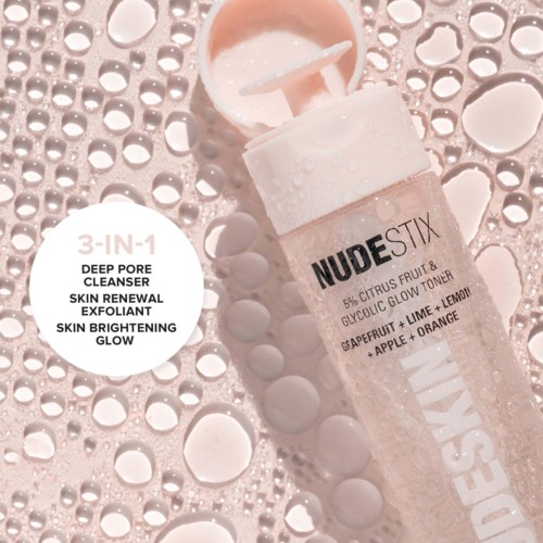 A skincare toner bottle with water droplets around it, labeled as a 3-in-1 product for skin renewal and brightening.
