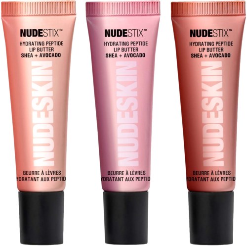 Three tubes of NUDESTIX lip butter with shea and avocado, in peach, pink, and brown colors.