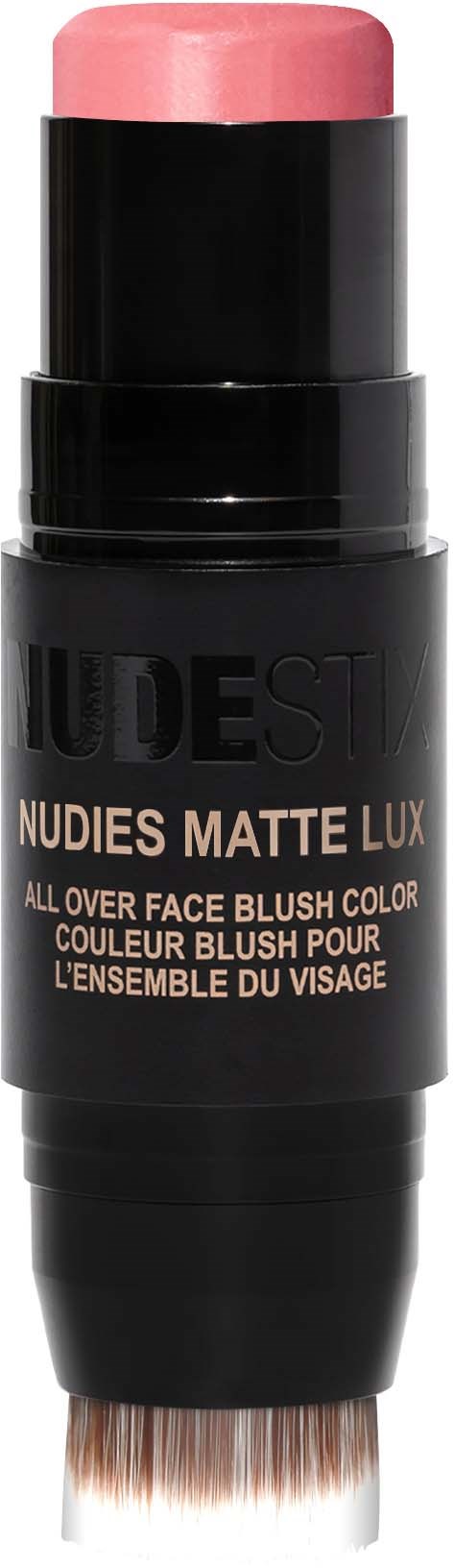 Een make-upstift met roze blush en een kwast, gelabeld als Nudestix Matte Lux gezichtsblush.