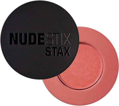 Eine runde schwarze Kompakt-Box mit Text und rosa Rouge. Logo für NUDESTIX STAX.