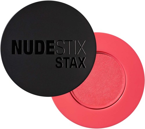 Ein Kosmetikkästchen mit schwarzen und pinken Behältern, eines mit der Aufschrift 'NUDESTIX STAX' und eine pinke Make-up-Palette.