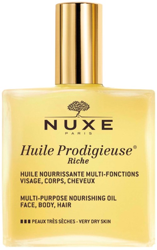 A yellow bottle with a gold cap labeled NUXE Huile Prodigeuse, for face, body, and hair. Suitable for very dry skin.