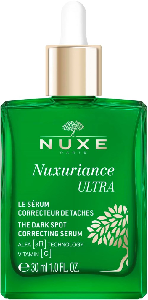 En grön glasflaska med en vit droppkork, märkt Nuxe Nuxuriance Ultra mörka fläckar korrigerande serum.