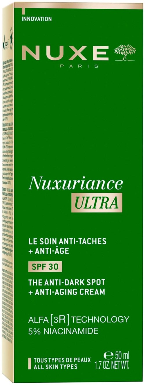 Grüner Karton mit weißen und grünen Text, bewirbt Anti-Pigmentflecken und Anti-Aging Creme mit SPF 30.