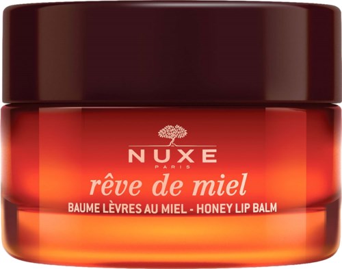 A small jar of honey lip balm with red and orange packaging, labeled Nuxe Rêve de Miel.