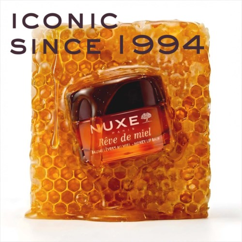 A honey-themed product with a honeycomb background and a small jar of honey lip balm in the center.