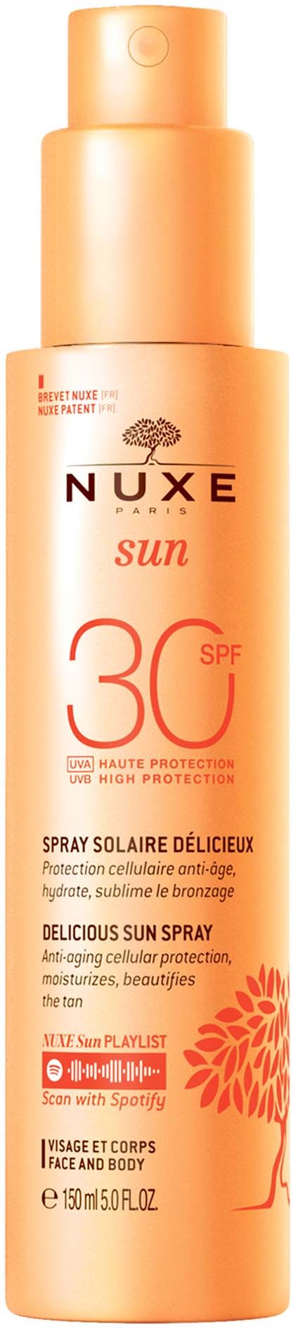 En flaska Nuxe Sun SPF 30 solskyddsspray för ansikte och kropp, med orange förpackning och blomsterdesign.