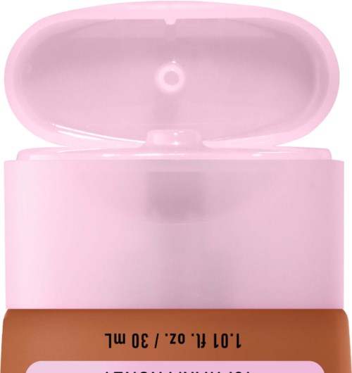 A pink container with an open lid, showing a small hole inside, and a brown label at the bottom.