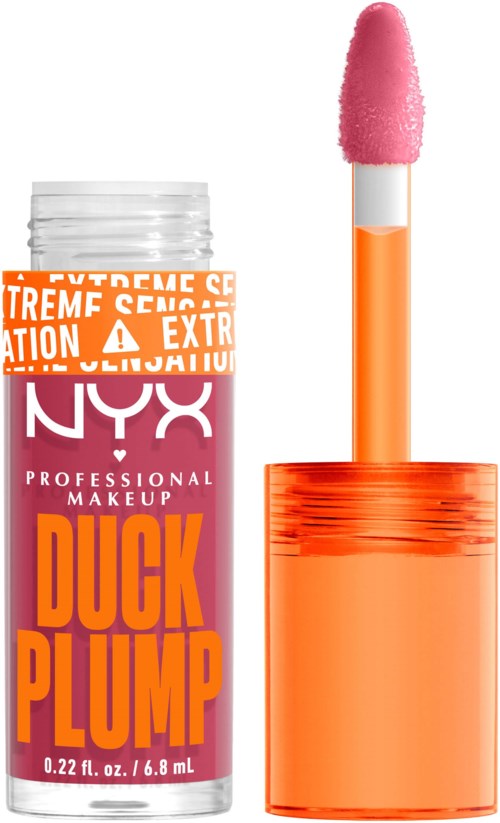 A tube of NYX professional makeup with a warning label, orange cap, and a pink makeup applicator stick.