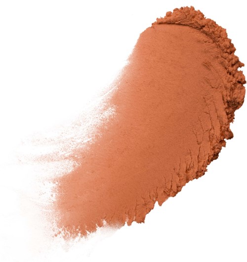 A peach-colored powder is spread out unevenly on a white background.