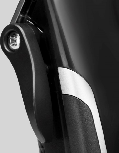 Close-up of a black handlebar with a circular light at the end, attached to a sleek, black device.