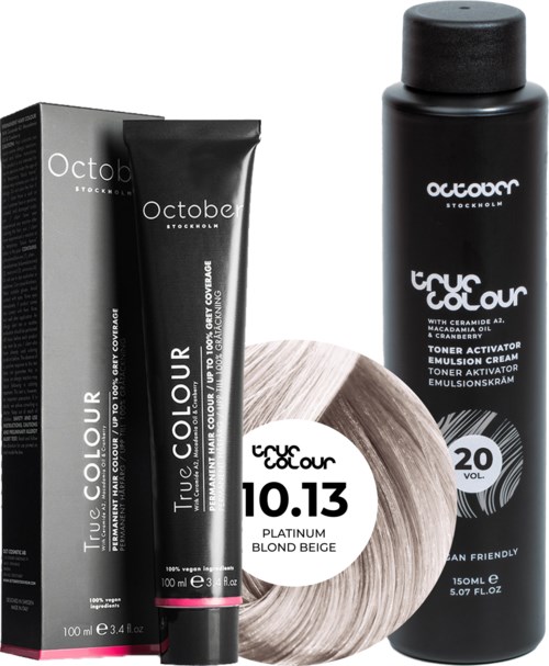 A black bottle and a black tube of hair color, with a round hair color sample in front, and a box behind.