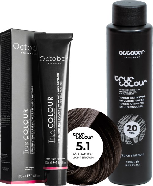 A black hair dye box, tube, and bottle labeled "True Colour" and "Octobe" with brown hair sample and volume 20.
