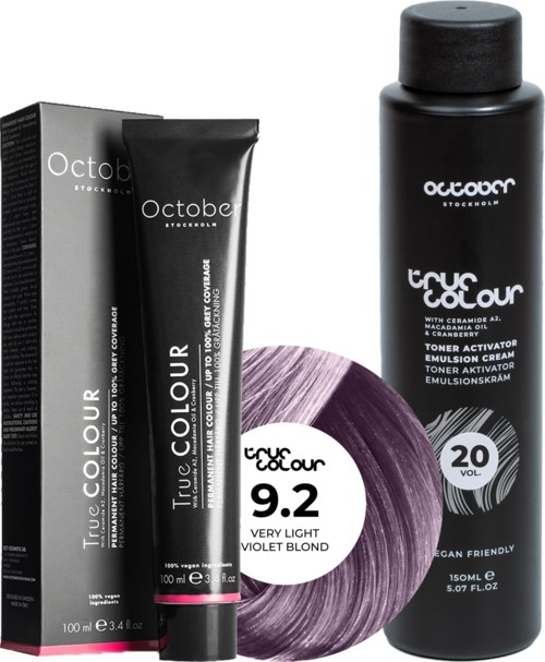 A hair dye kit with a black tube of color, a box, and a purple hair color sample labeled "9.2 Very Light Violet Blond."