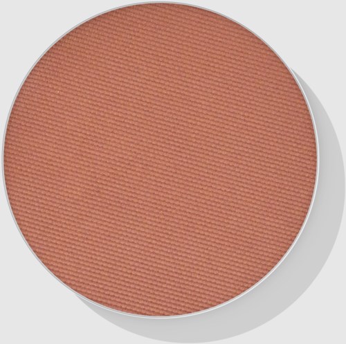 Een ronde make-up blush met een zachte perzikkleur en getextureerd oppervlak.