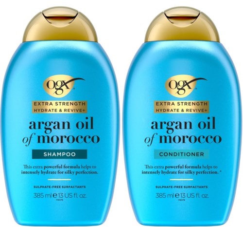 Kaksi sinistä pulloa marokkolaisesta arganöljystä, toisessa shampoo ja toisessa hoitoaine, kultareunaisilla korkkeilla.