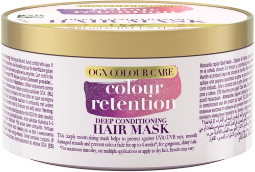 Die Verpackung trägt die Bezeichnung 'OGX Colour Care colour retention Deep Conditioning Hair Mask' für gepflegtes Haar. Das Etikett ist violett, pink und gold.