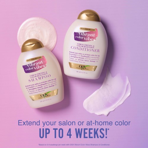 Twee flessen haarverzorgingsproducten, één shampoo en één conditioner, met paarse en gouden doppen, op een paarse achtergrond.