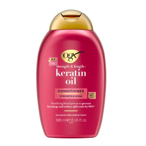 Red bottle of OGX keratin oil conditioner with gold cap, labeled for strength, shine, and reducing split ends.